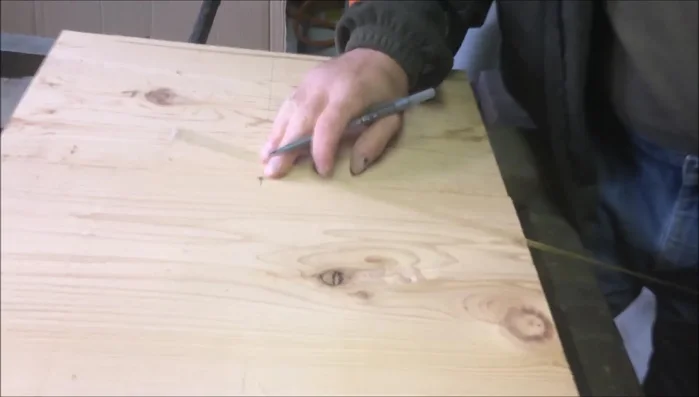 Place the nail in the center of the square base and use the jig to draw a circle.