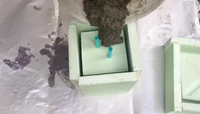 Add support to hold the molds together while the concrete sets.