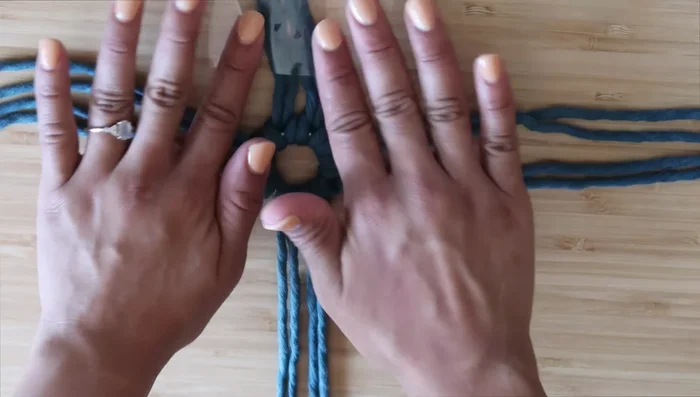 Divide the cords into four sections (two cords per section). Create ten square knots in each section.