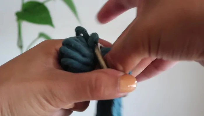 Create three square knots at the bottom to secure the O-ring.