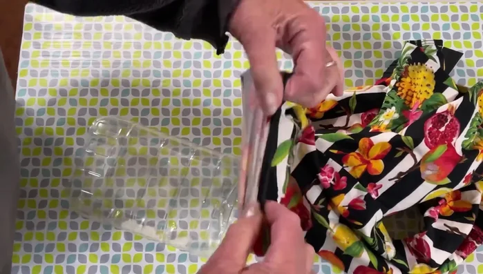 Slip the fabric over the container, ensuring it's snug.