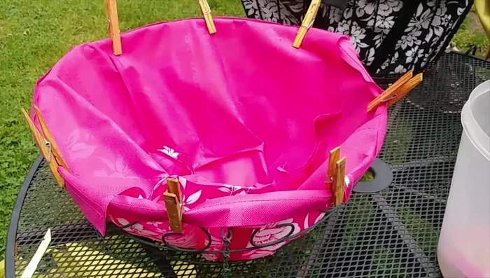 Use clothespins to hold the edges of the liner in place while adding soil.