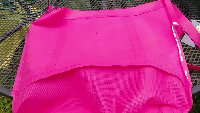 Lay the bag into the basket, covering one half. Secure it with safety pins.