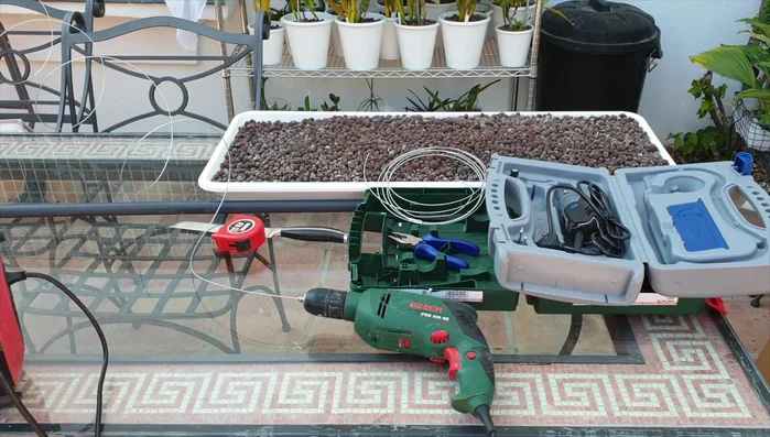 Straighten the wire using a drill. Insert the end of the wire into the drill chuck, tighten securely, and run the drill to straighten the wire.