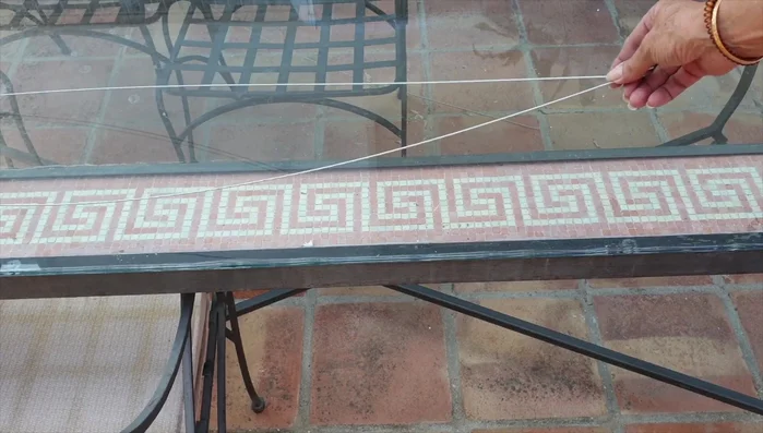 Cut a piece of wire to the desired length, doubling it over to create a hook at the top.