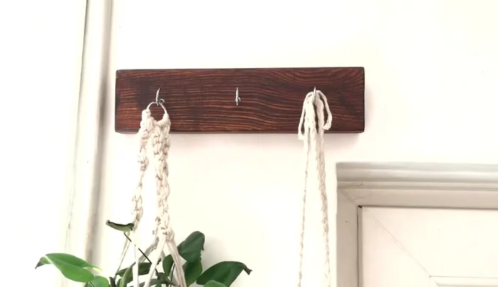 Attach the hook to the wall using strong command strips.