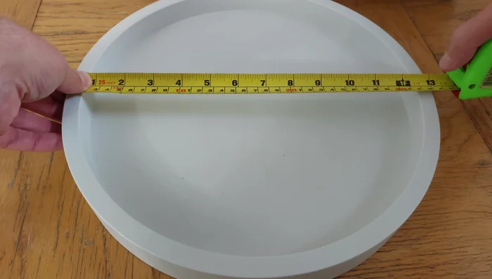 Select a caddy slightly larger than your pot's inside diameter to accommodate the curve of the pot and ensure a snug fit.