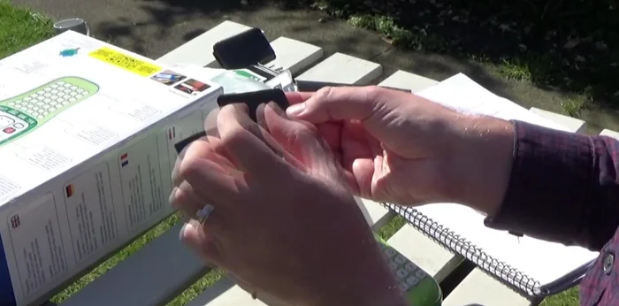 If necessary, trim the label to fit within the plastic label using scissors.