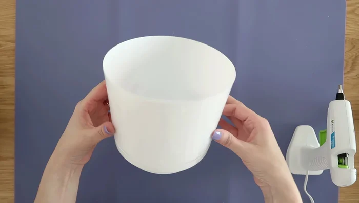 Make a simple lantern using a small Dollar Tree planter and a hot glue gun to melt holes for candlelight.