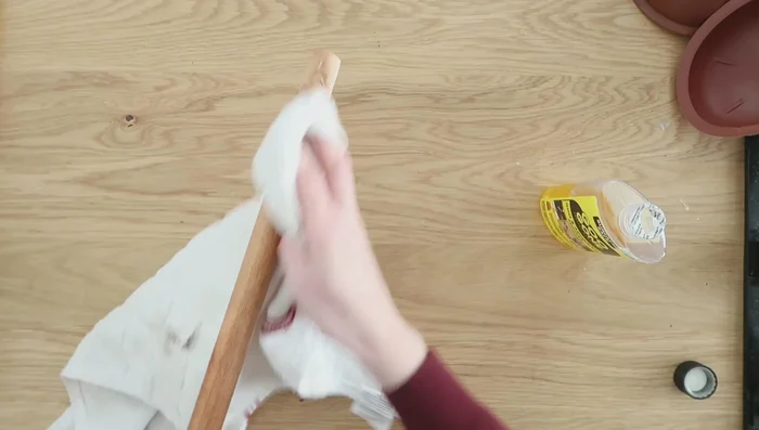 Create a plant stand using plunger handles, a Dollar Tree planter, gel super glue, and hot glue.