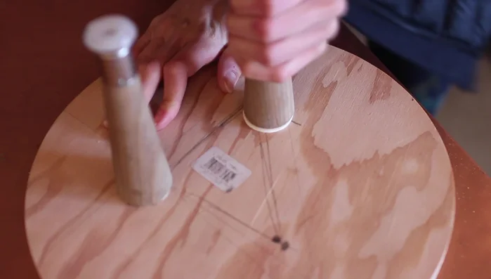 Screw the legs into the holes, adding wood glue for extra security.